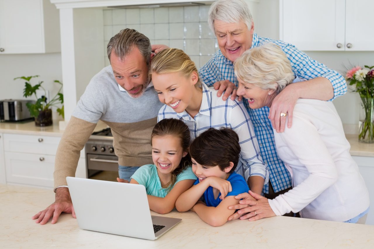 Family using laptop in kitchen